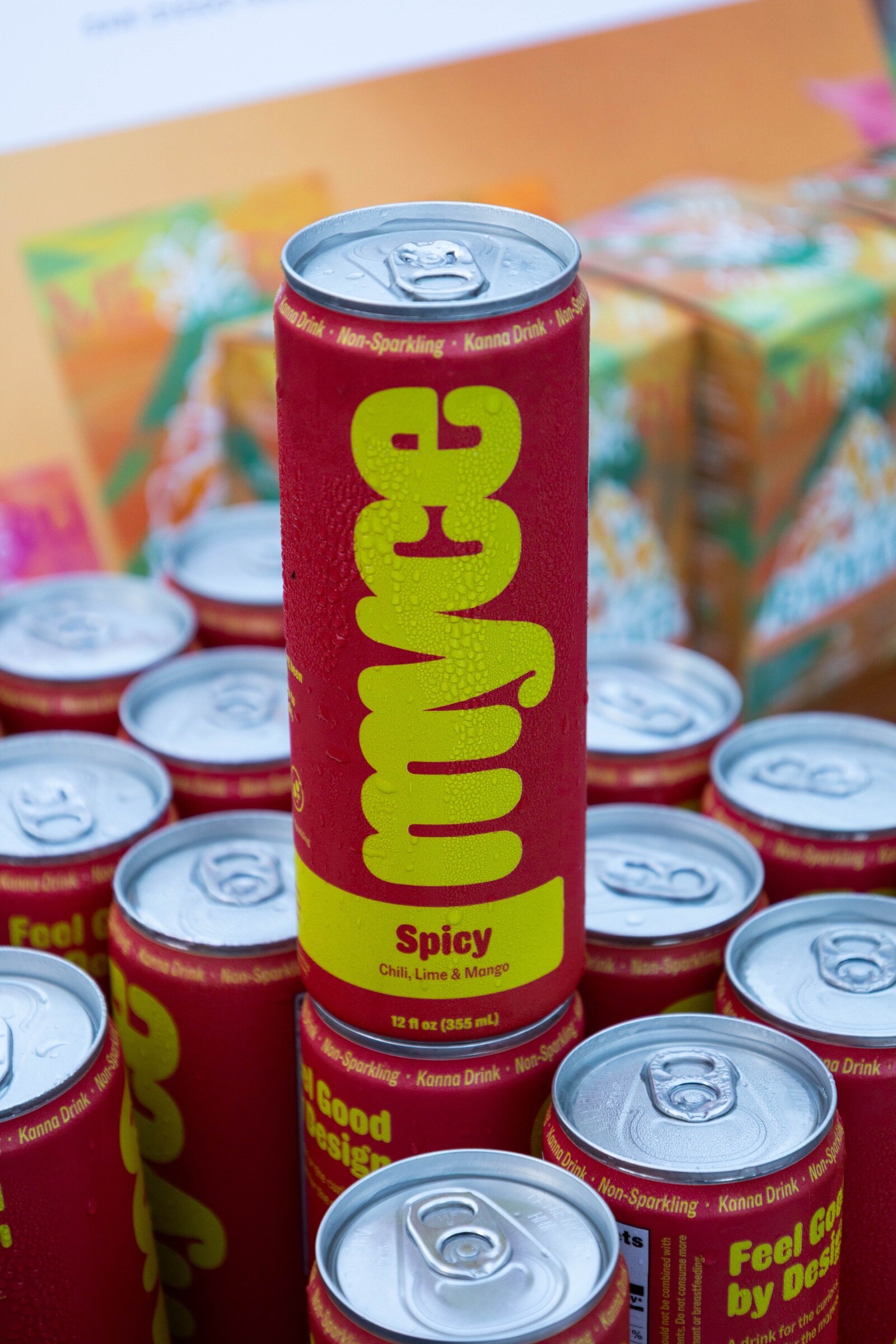 Red can of Myce Spicy standing on top of a cluster of Myce cans.