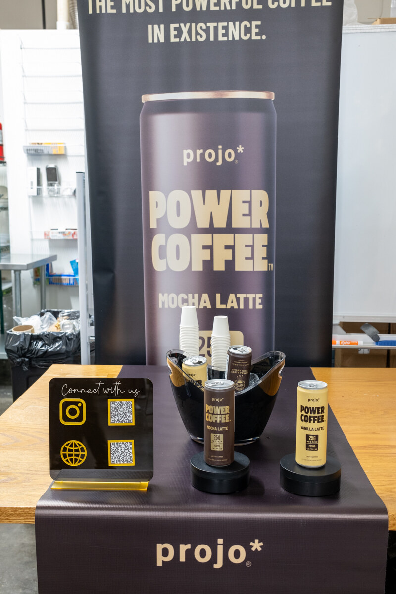Projo Power Coffee mocha latte display with a can and sample bottles.