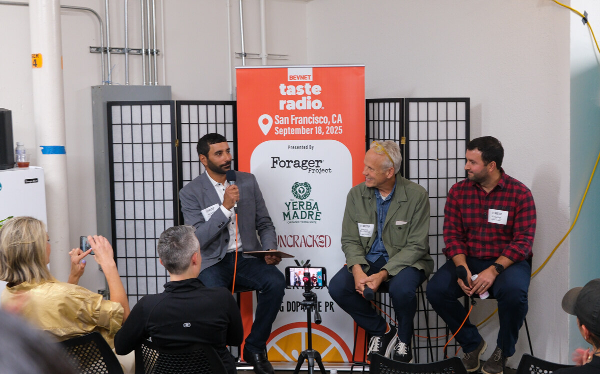 Three men seated on stools in front of an orange banner listing Forager Project, Yerba Madre and Uncracked.
