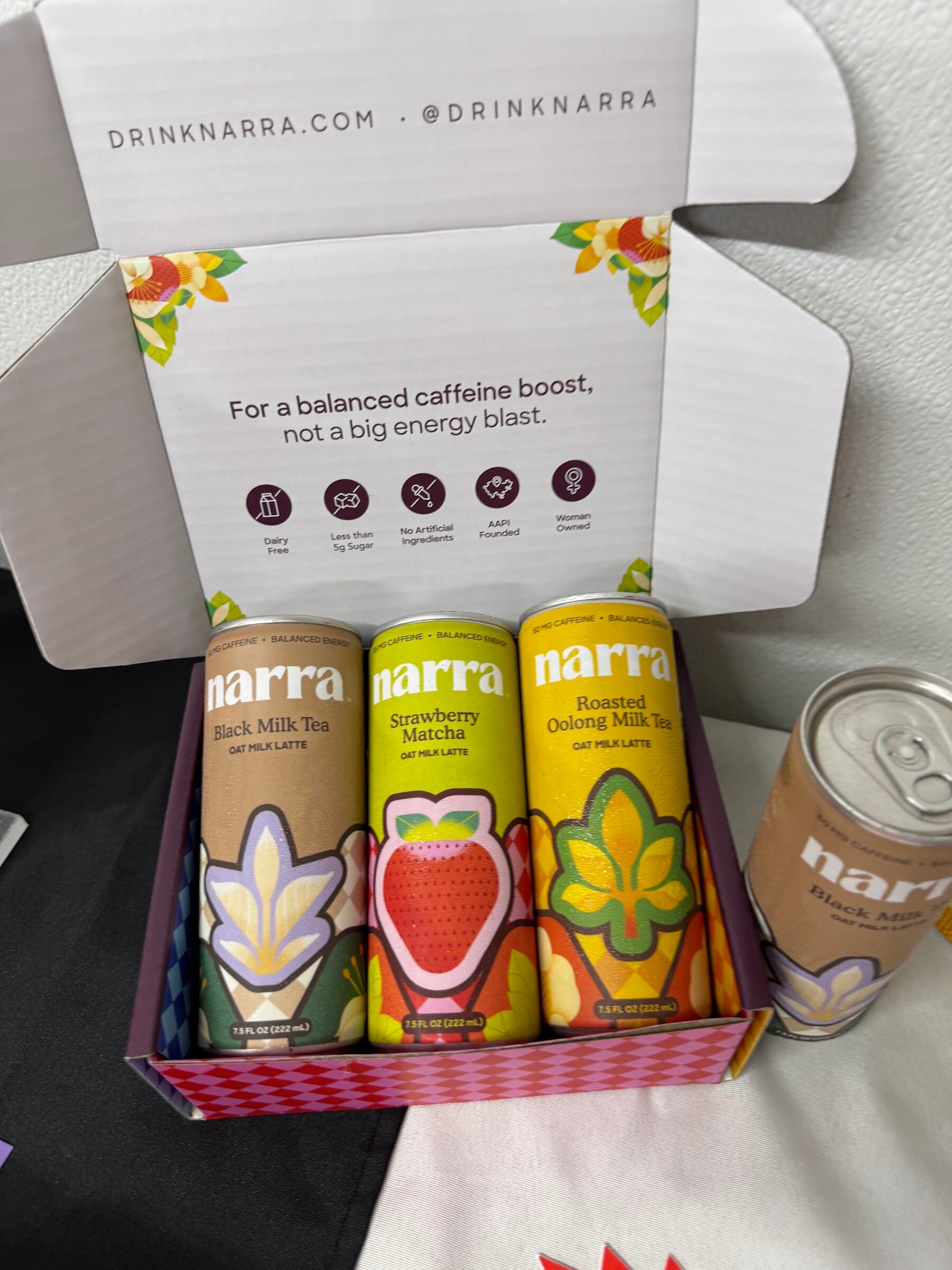 Open gift box of Narra canned drinks beside a loose can.