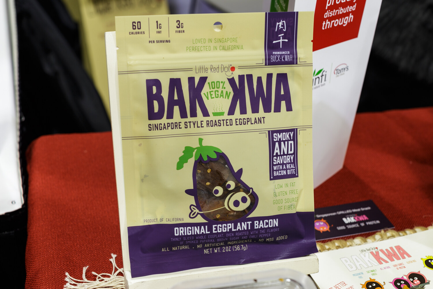 A package of Bakkwa original eggplant bacon on a red cloth.