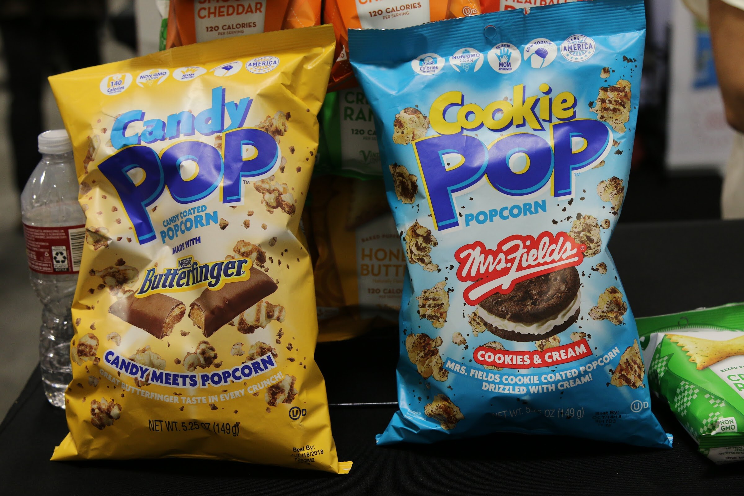 Two large bags of popcorn labeled Candy Pop and Mrs. Fields Cookie Pop.