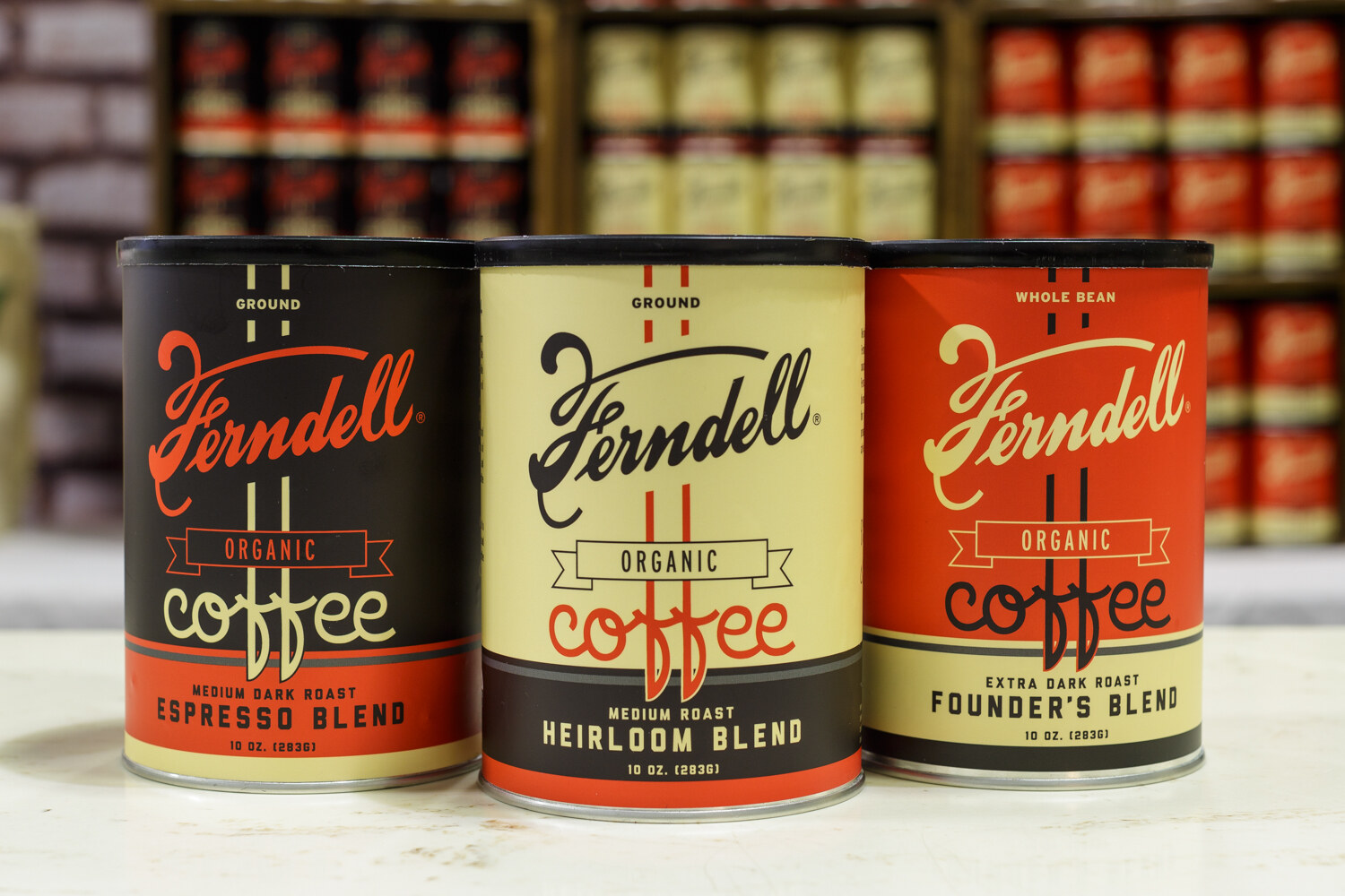 Three tins of Ferndell organic coffee in espresso, heirloom and founder's blends.