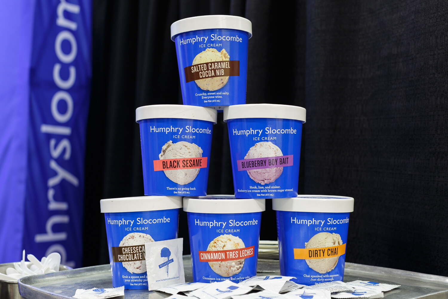 Pints of ice cream with colorful labels on display.