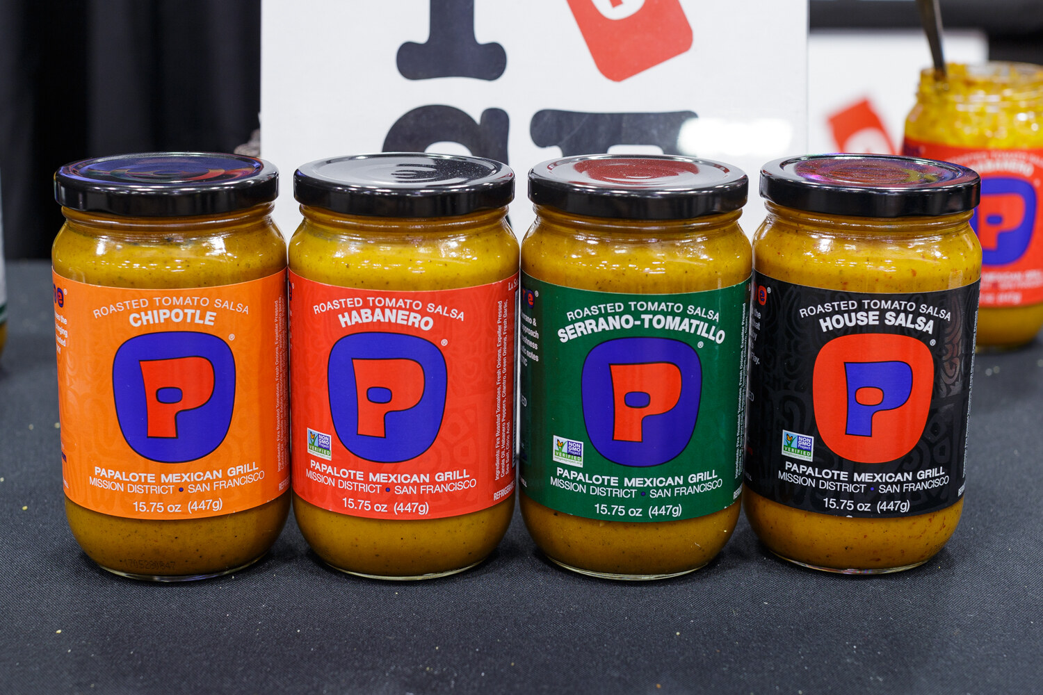 Four jars of salsa with orange and blue labels.