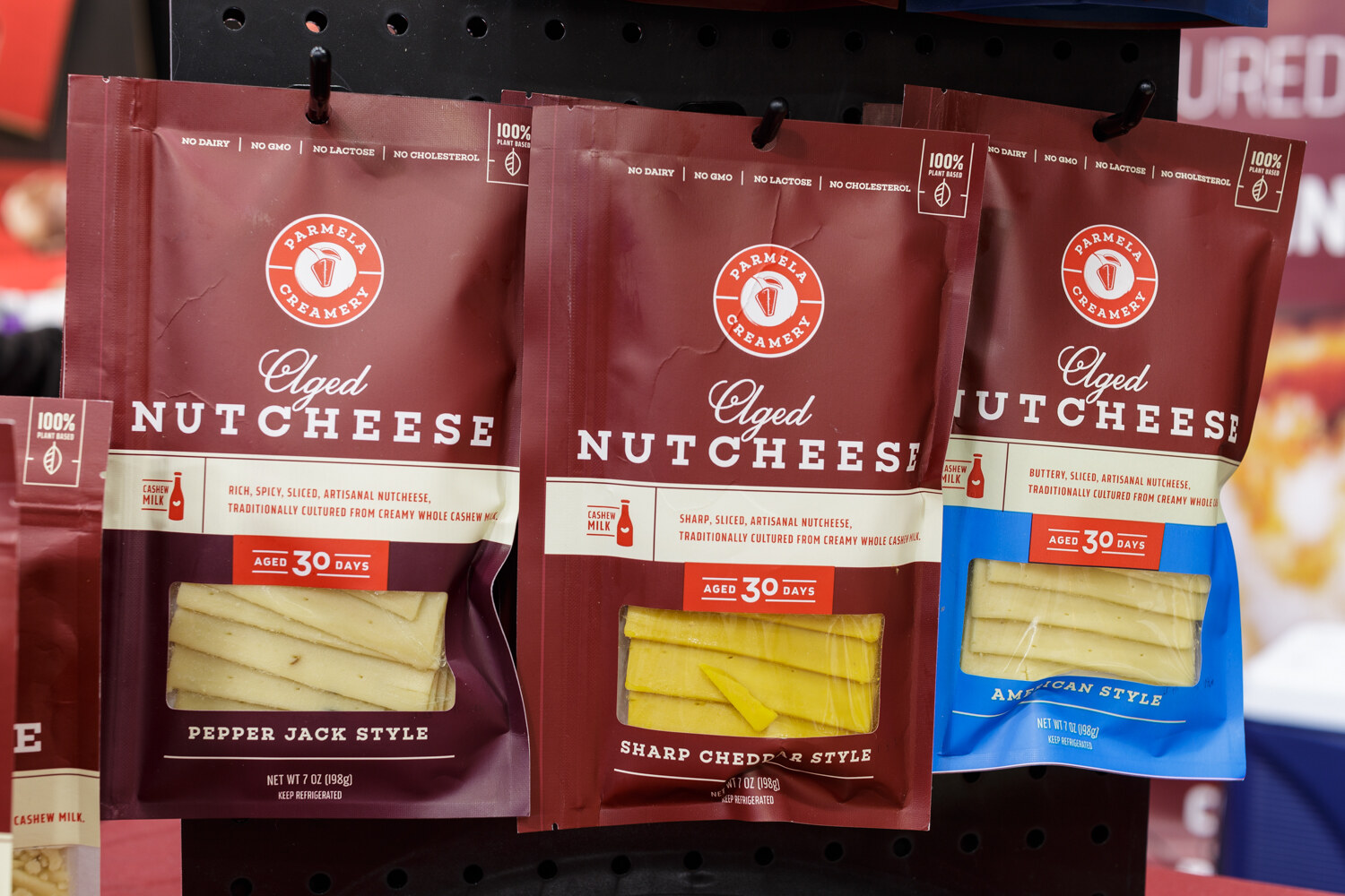 Hanging packages of sliced nut-based cheese.