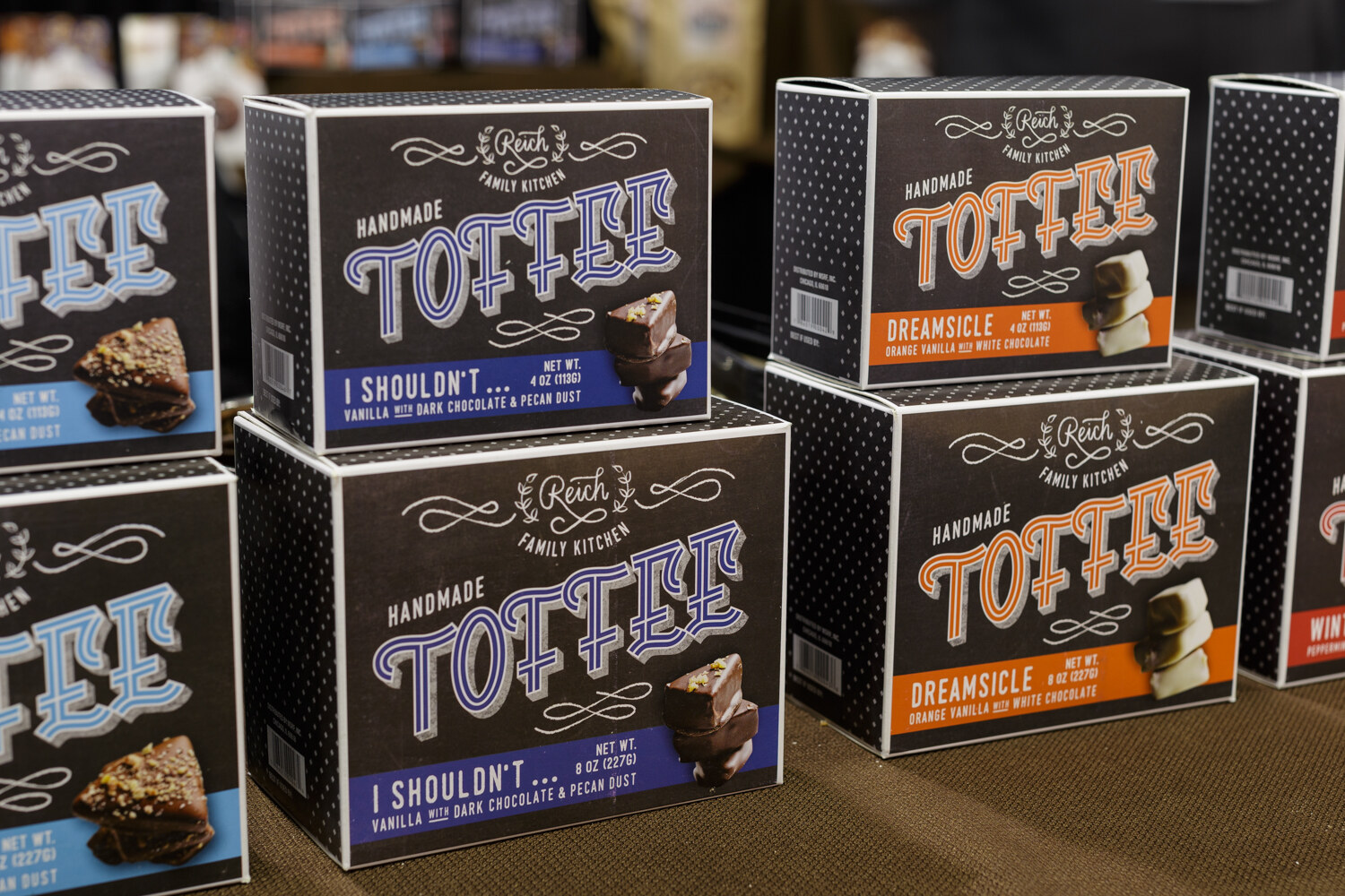 Stacked boxes of toffee with bold lettering.