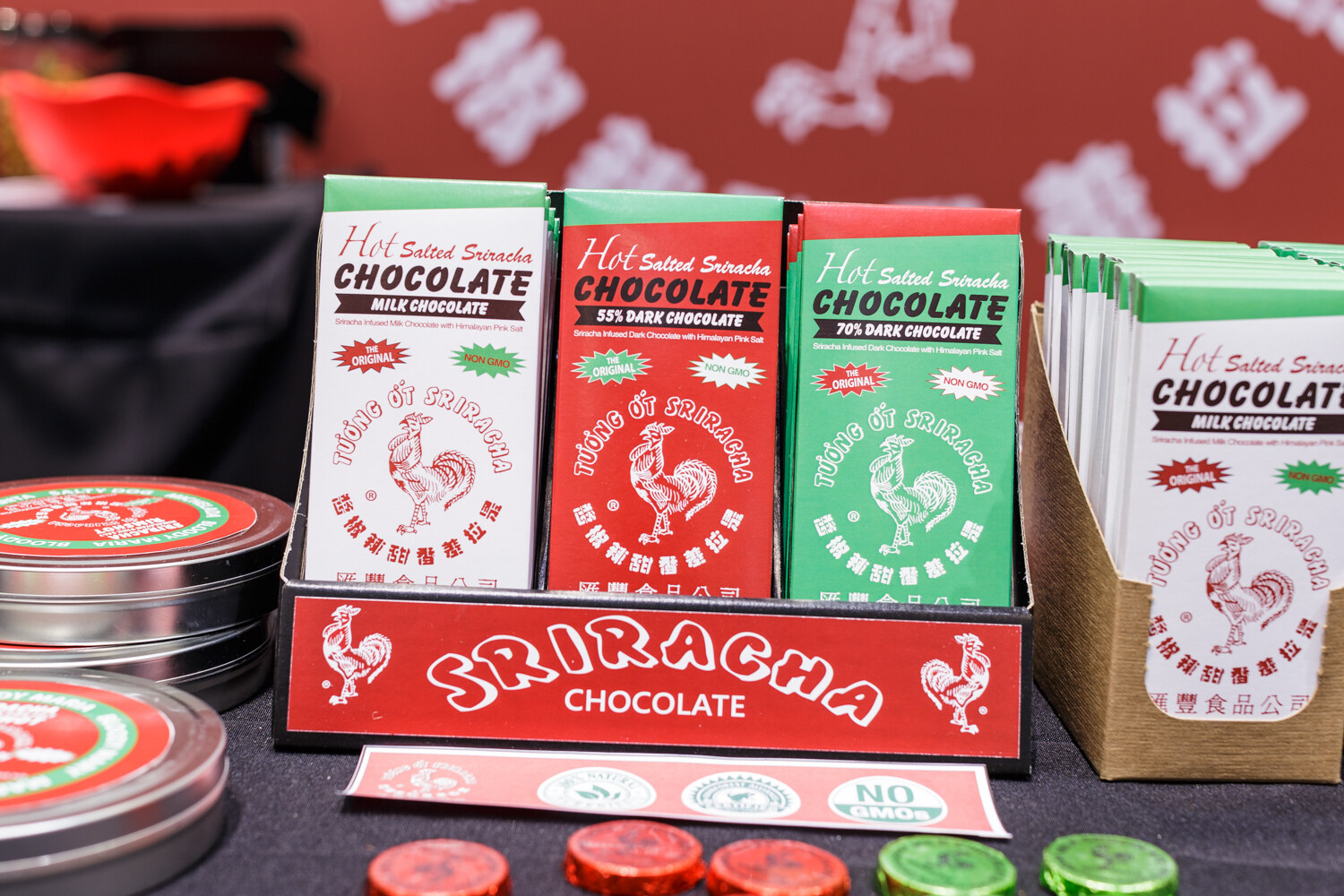 Display of Hot Salted Sriracha chocolate bars with a rooster logo.