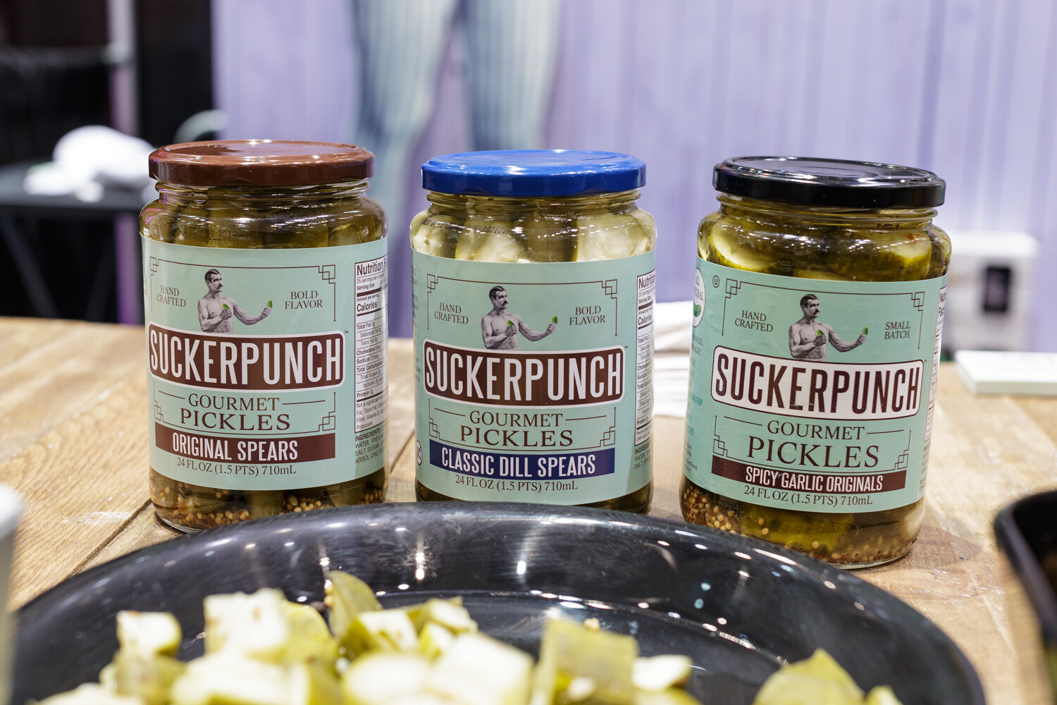 Jars of pickles on a shelf.