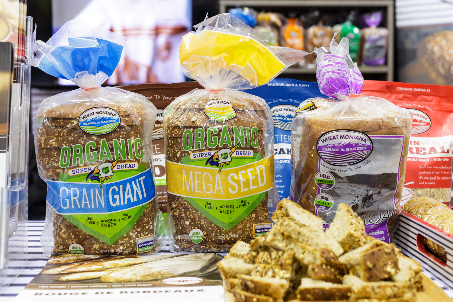 Loaves and bags of baked goods on a display.