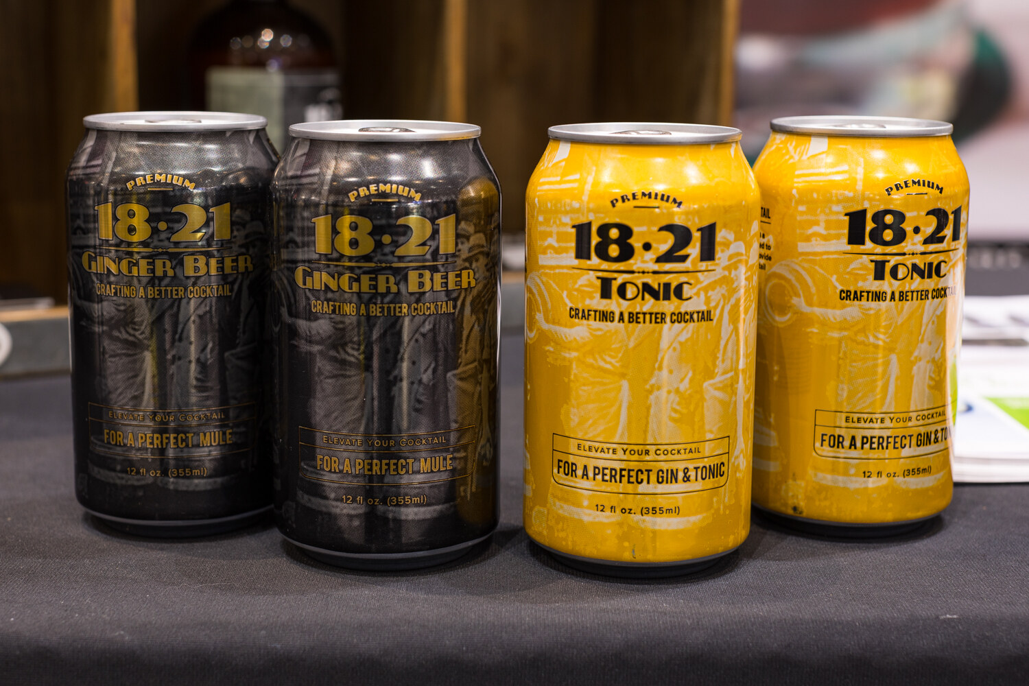 Photo of cans of 18.21 ginger beer and tonic on a table.