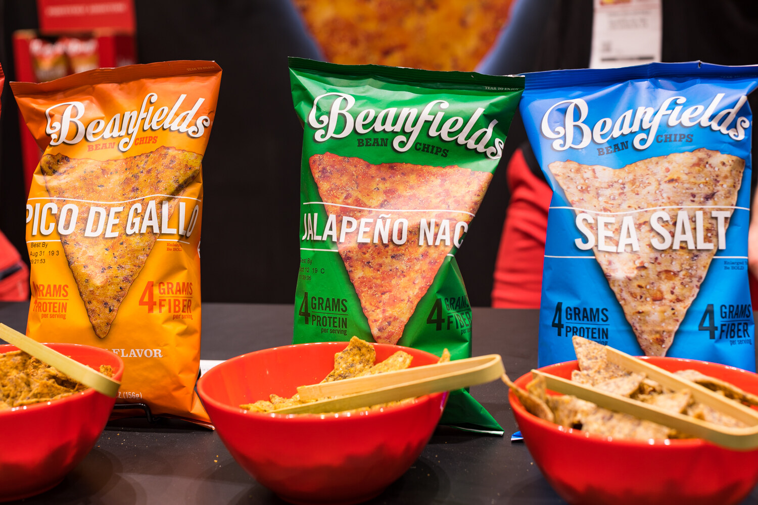 Photo of Beanfields chips in three flavors with red bowls of samples.