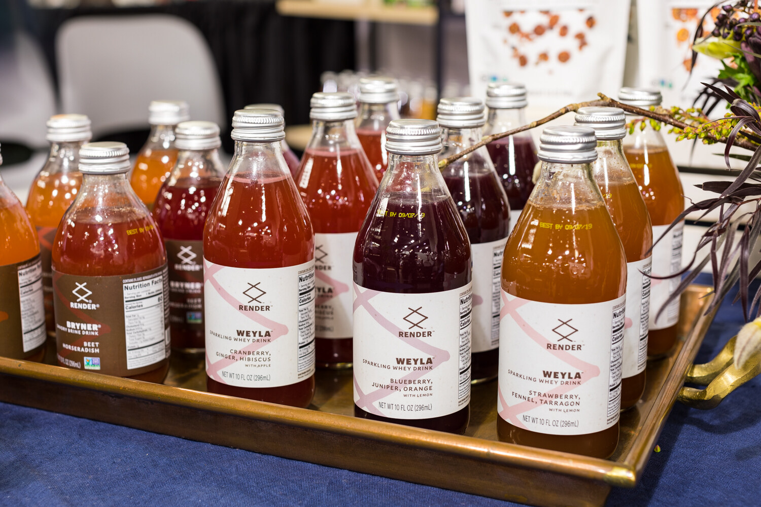 Photo of bottles of Bender sparkling tonic in a copper tub beside tasting cups.