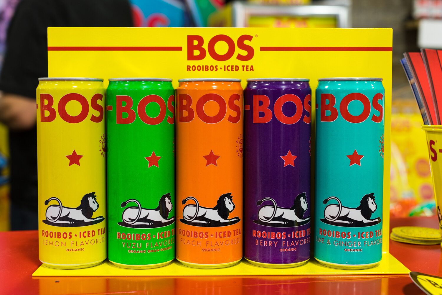 Photo of five tall cans of BOS rooibos iced tea in different colors.