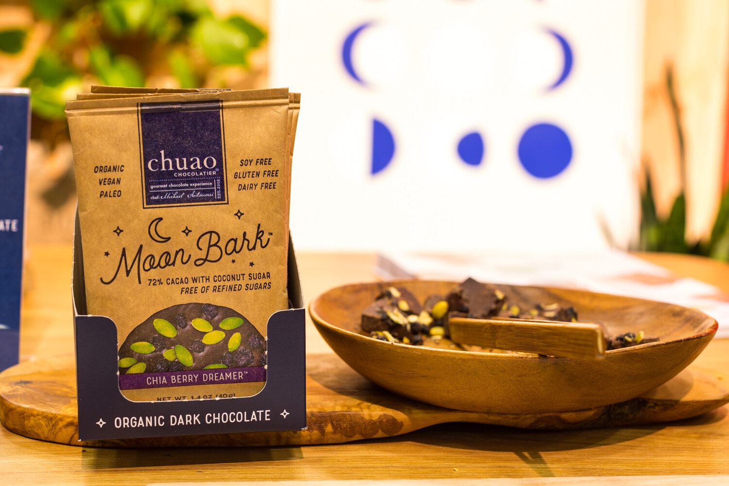 Photo of a Chuao Moon Bark chocolate package beside a bowl of broken pieces.
