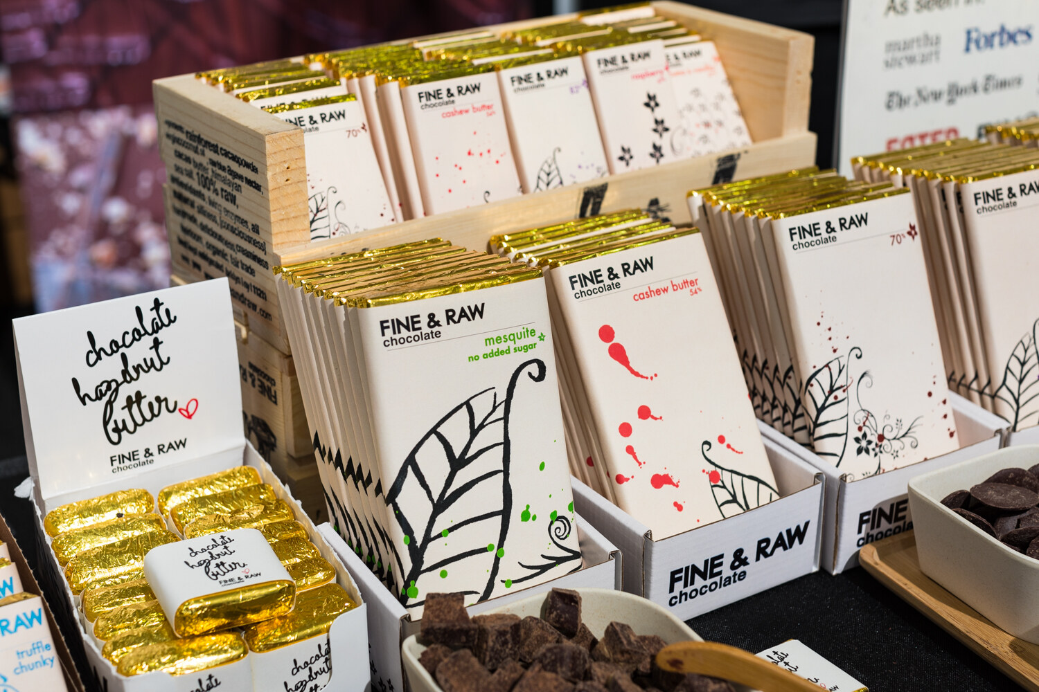 Photo of Fine & Raw chocolate bars in a wooden display with a handwritten sign.