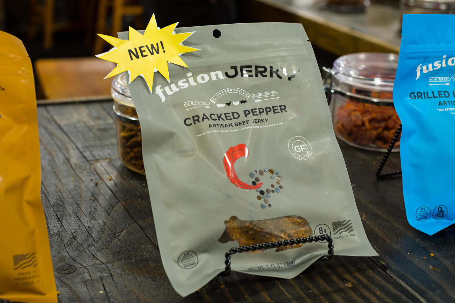Photo of a bag of Fusion Jerky cracked pepper with a New starburst.