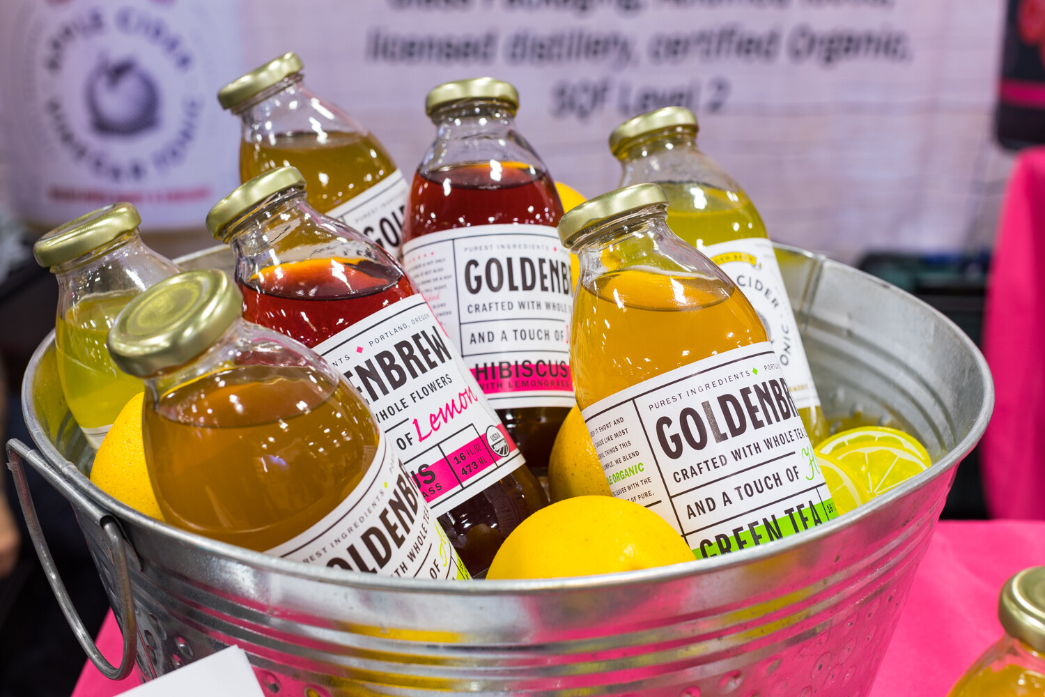 Photo of Goldenbrew bottles in a metal bucket with lemons and limes.