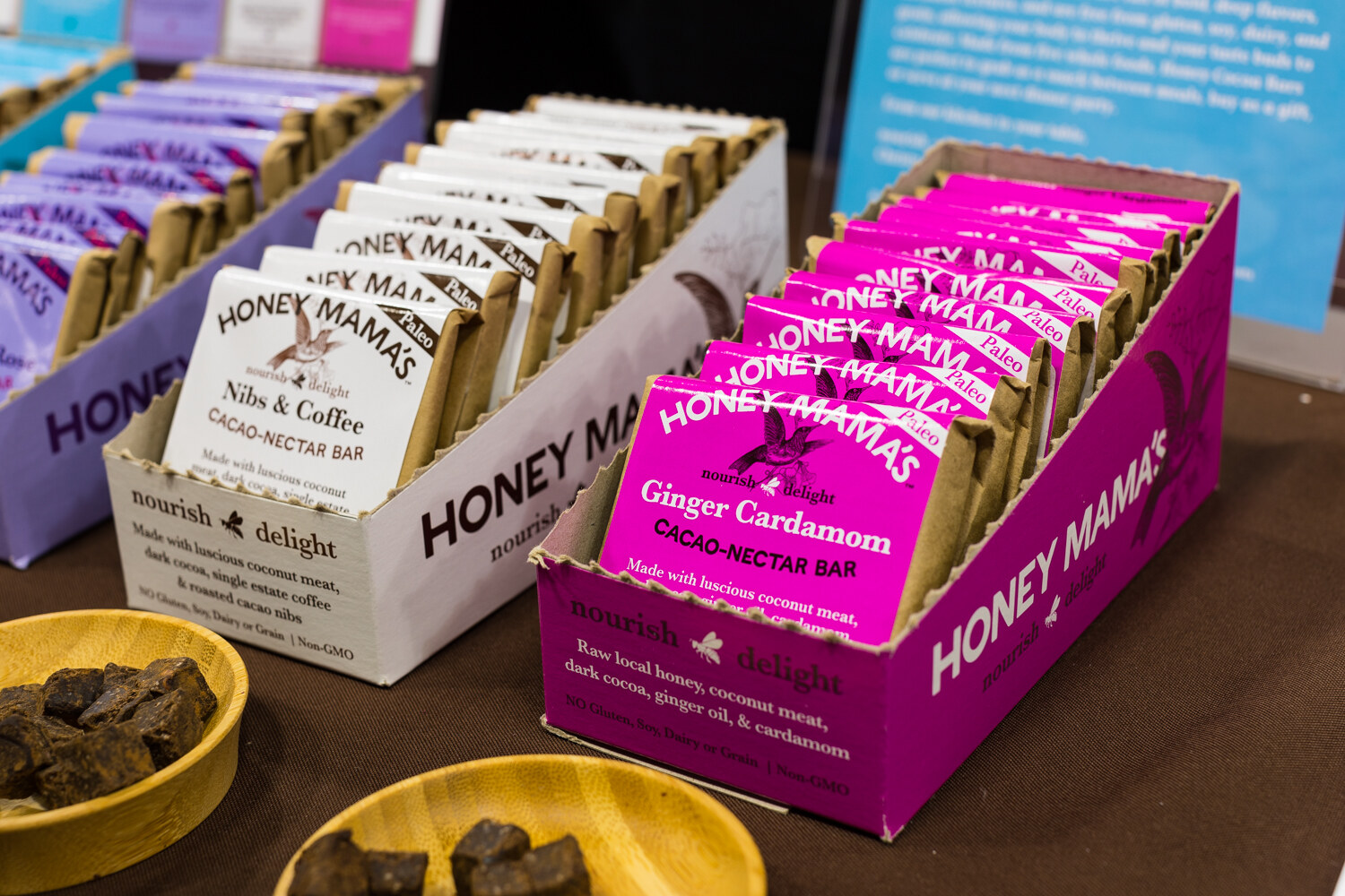 Photo of Honey Mama's cacao nectar bars in open display boxes with chocolate samples.