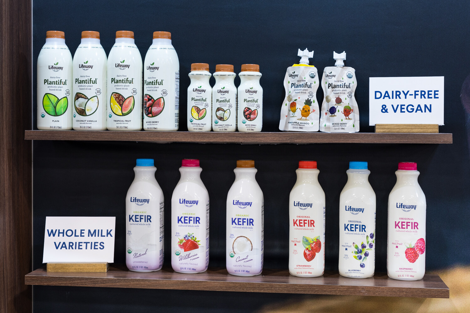 Photo of a shelf of Lifeway Plantiful and kefir bottles with dairy-free and vegan signs.