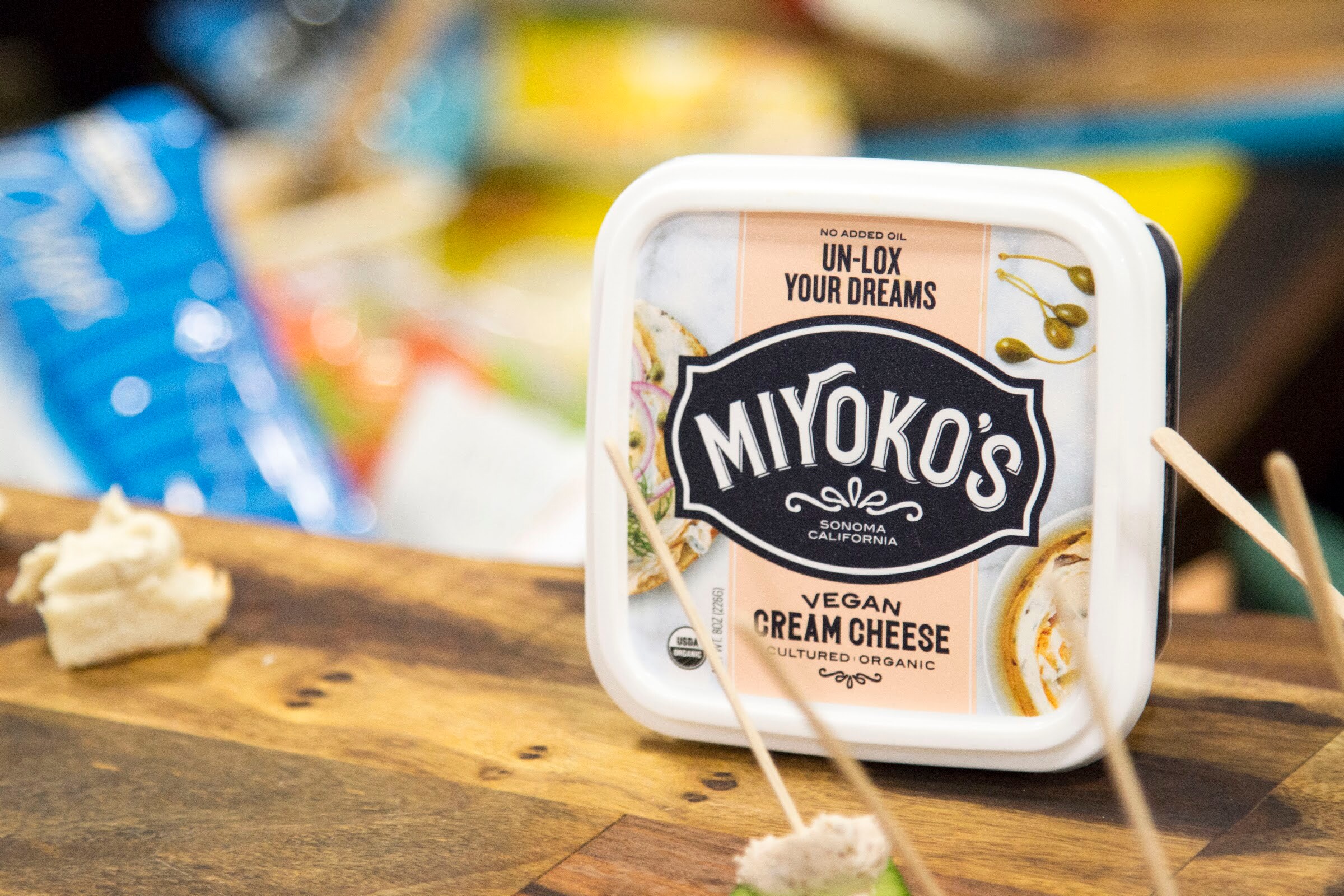 Photo of a tub of Miyoko's vegan cream cheese with toothpick samples.