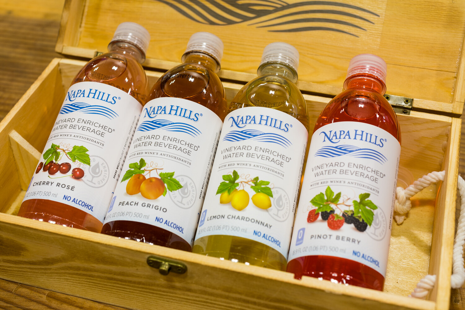 Photo of four bottles of Napa Hills vineyard enriched water beverages in a wooden crate.