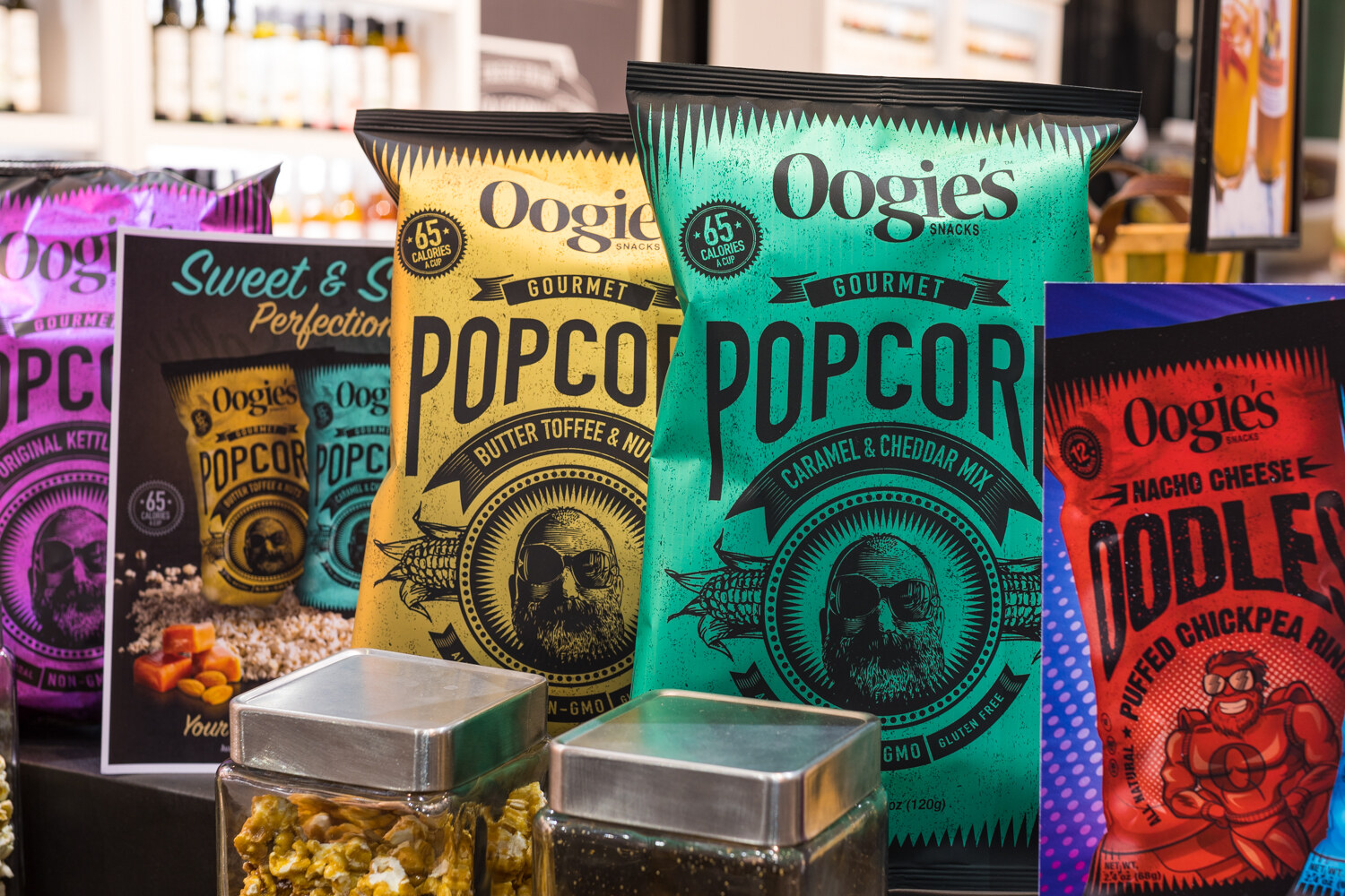 Photo of bags of Oogie's gourmet popcorn and chickpea snacks.