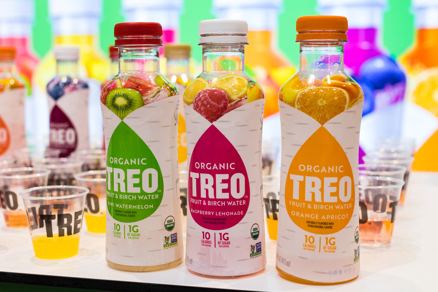 Photo of bottles of Treo fruit and birch water with tasting cups.