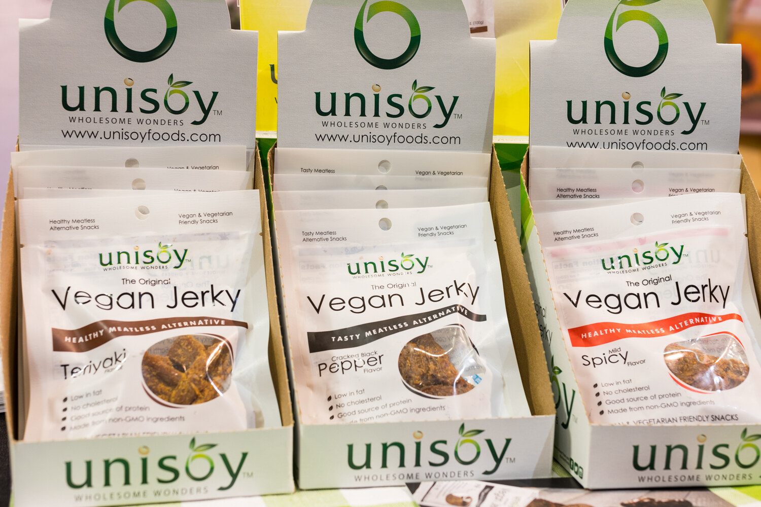 Photo of boxes of Unisoy vegan jerky in teriyaki, pepper and spicy.