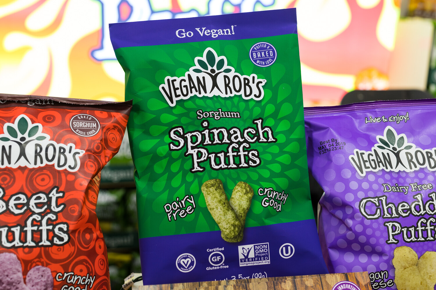 Photo of a bag of Vegan Rob's spinach puffs with other puff flavors behind.