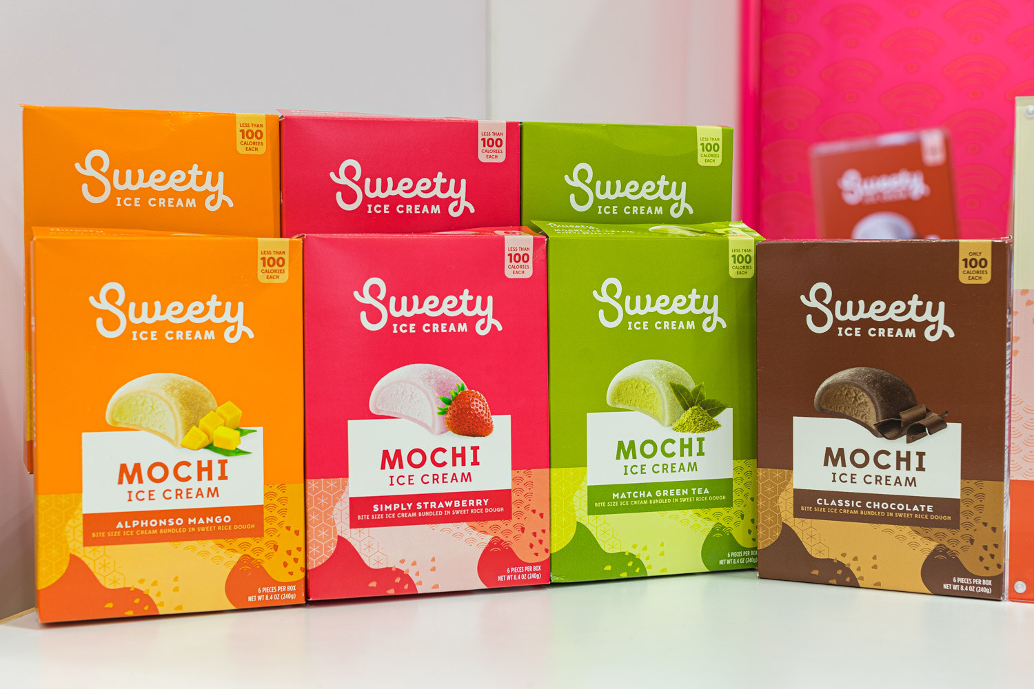 Four colorful Sweety Mochi Ice Cream boxes in alphonso mango, simply strawberry, matcha green tea and classic chocolate