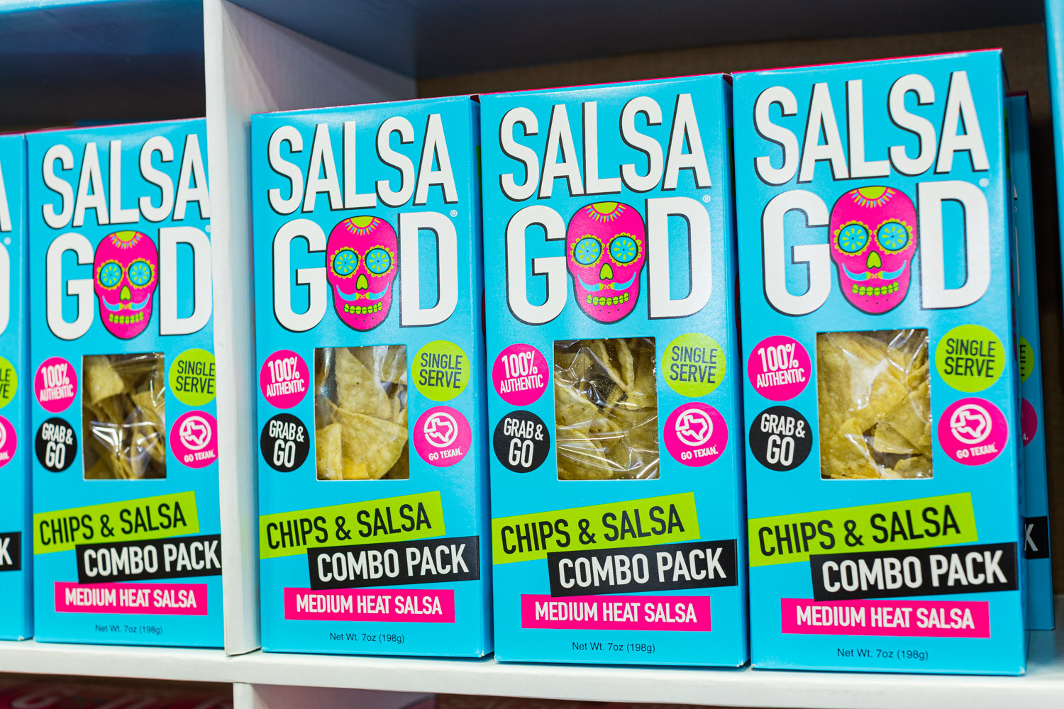 Three blue Salsa God Chips and Salsa Combo Pack boxes with a skull logo
