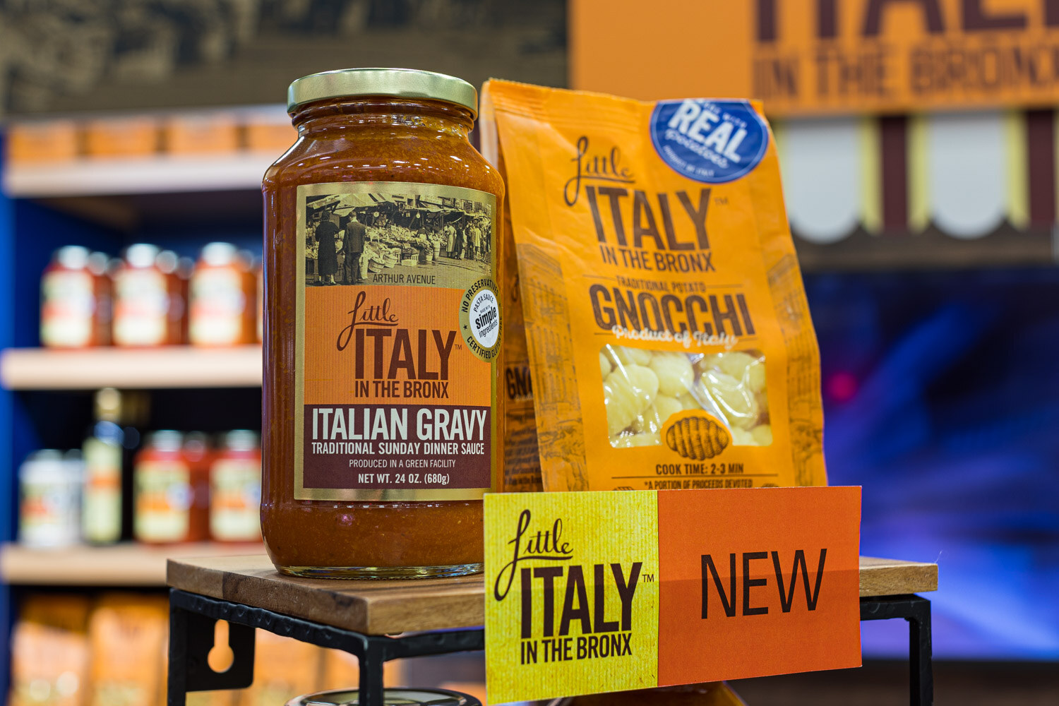 A jar of Little Italy in the Bronx Italian gravy and a bag of gnocchi with a New sign