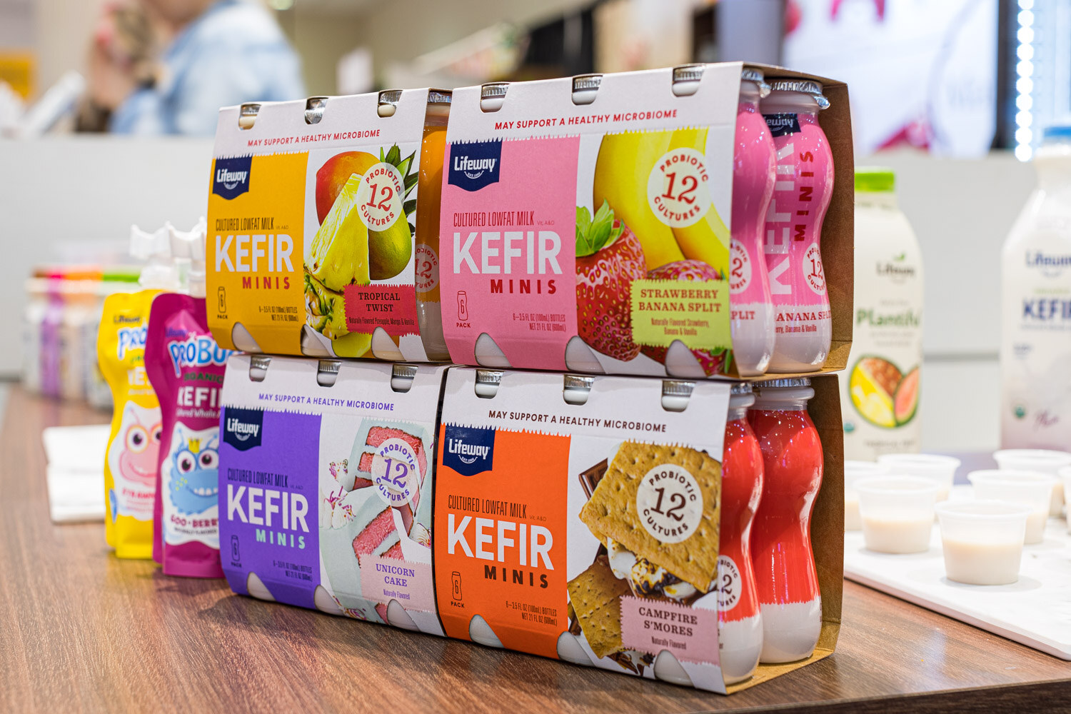 Stacked Lifeway Kefir Minis multipacks in tropical twist, strawberry banana split, unicorn cake and campfire s'mores flavors