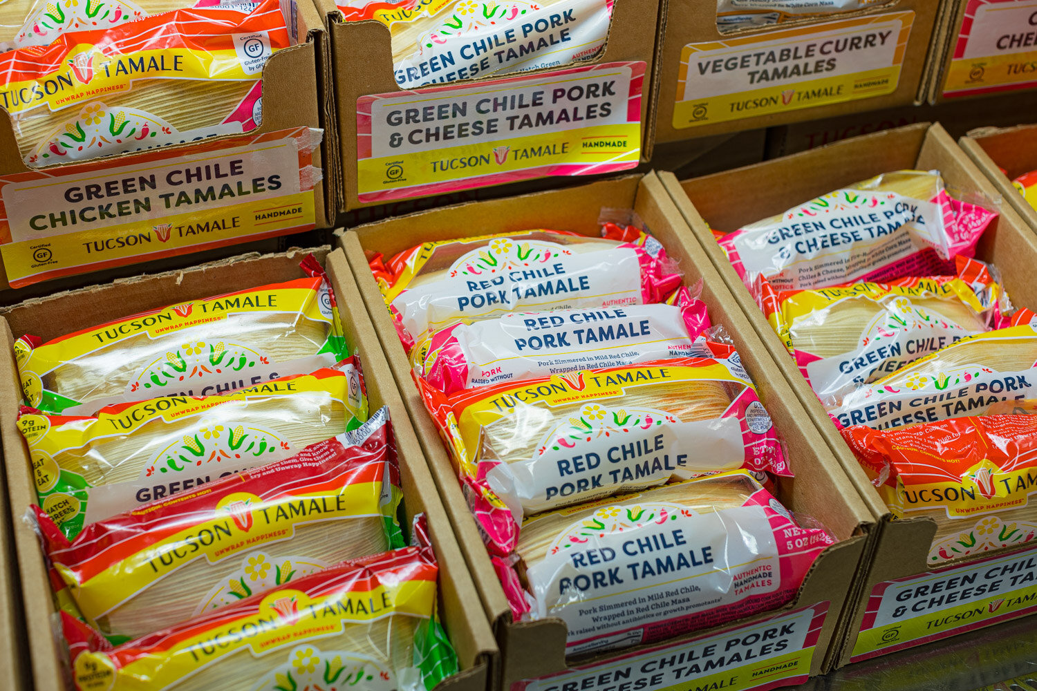 Cardboard trays packed with Tucson Tamale green chile chicken, pork and cheese tamales