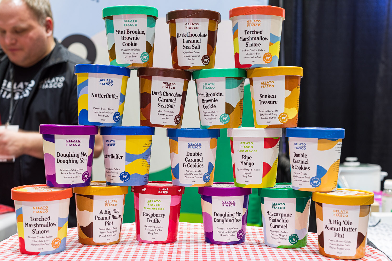 A pyramid of Gelato Fiasco pints on a red checkered tablecloth