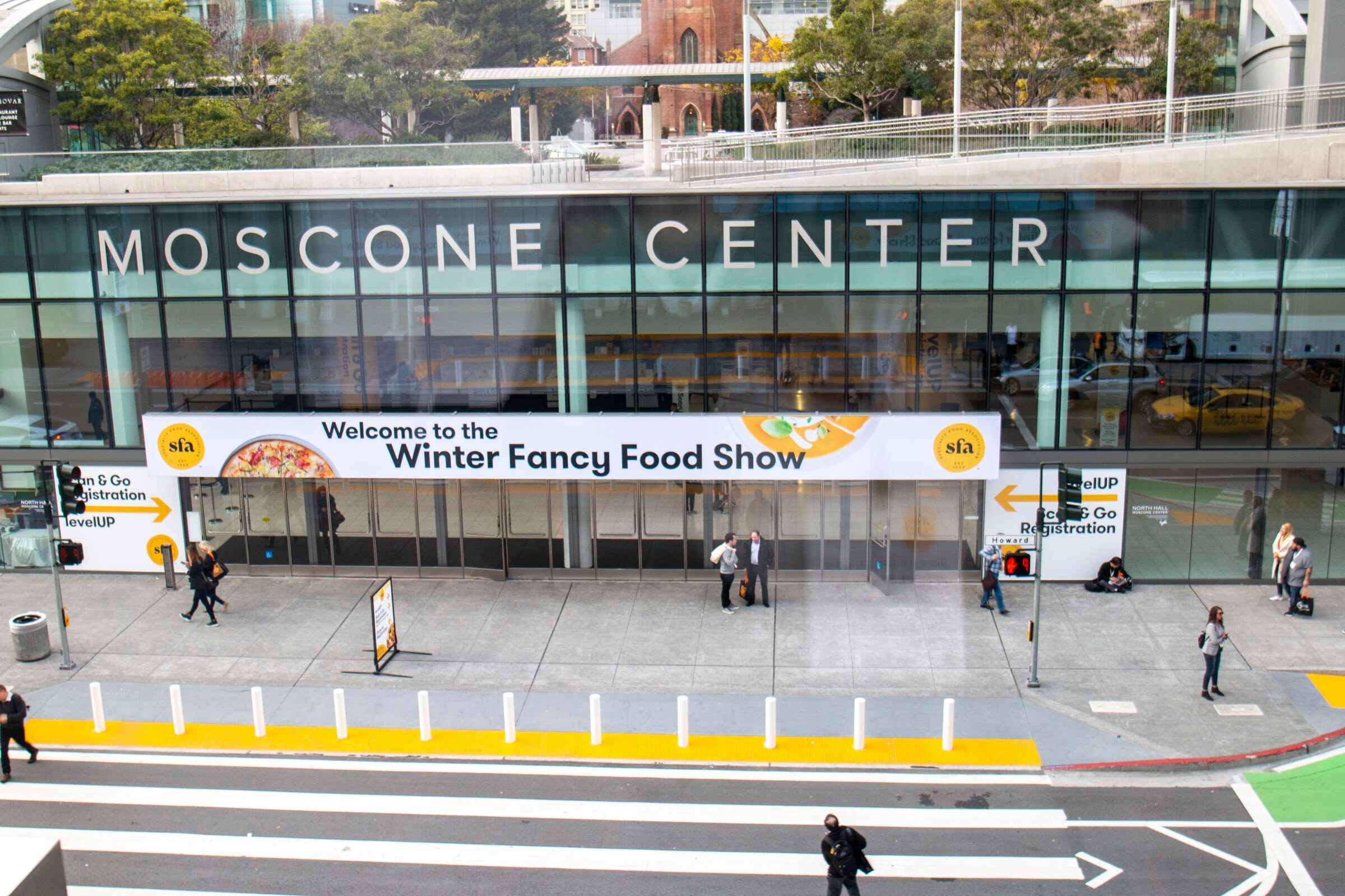 Exterior of the Moscone Center seen from above with a Winter Fancy Food Show banner across the entrance