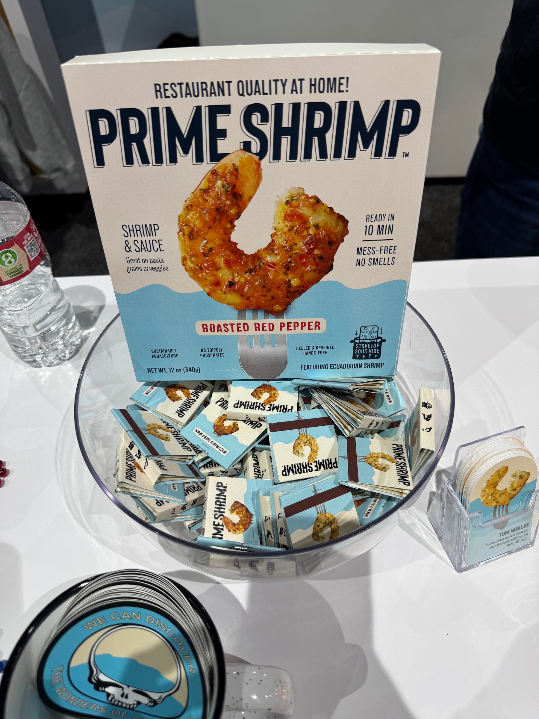 A Prime Shrimp roasted red pepper box above a glass bowl of Prime Shrimp packets.