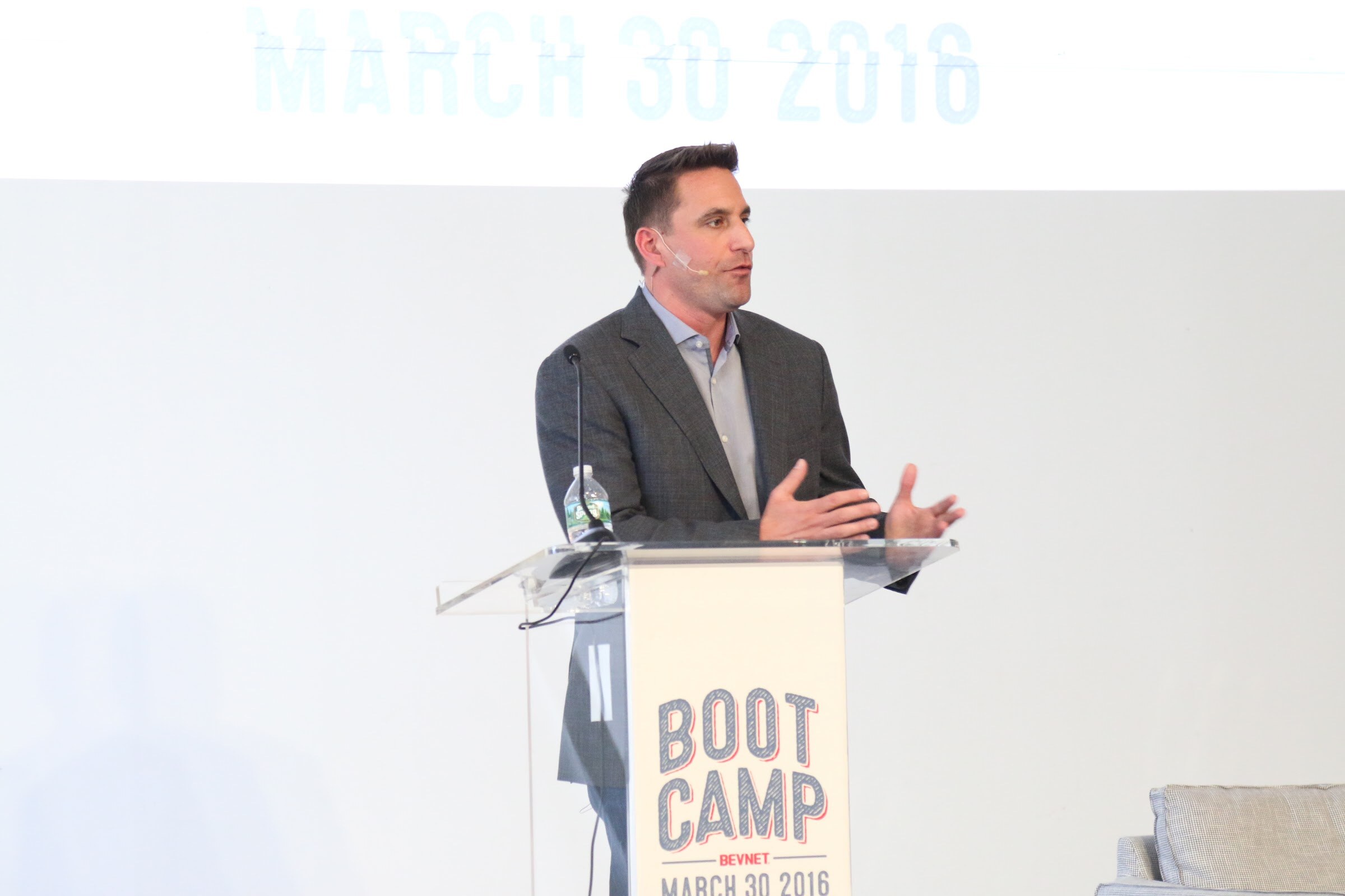 Presenter at podium both hands out, screen reads March 30 2016.