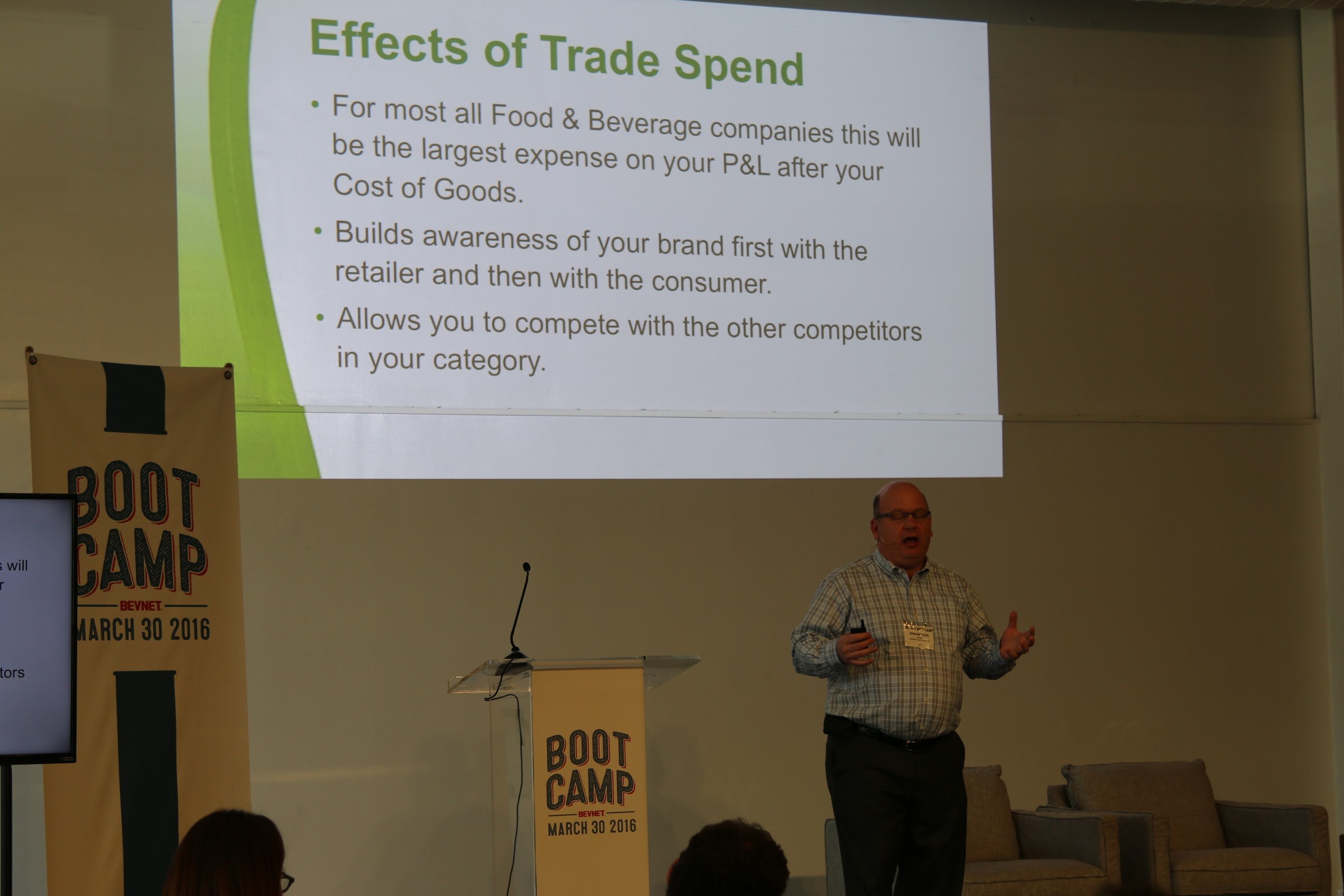 Presenter mid-gesture, slide Effects of Trade Spend.