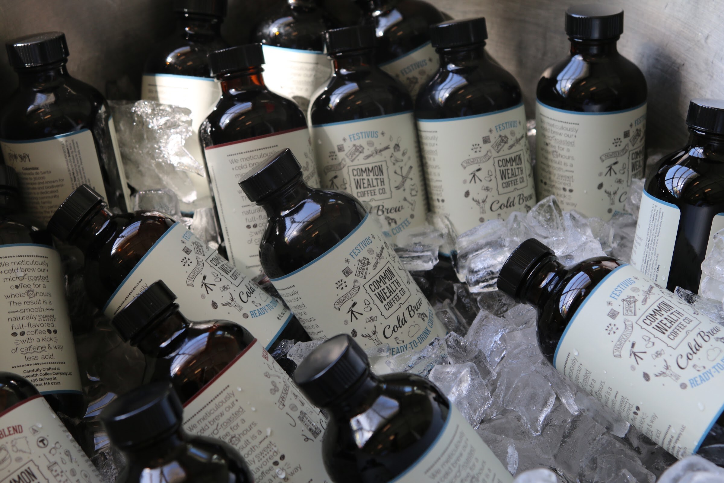 Cold brew bottles Common Wealth Coffee Co on ice.