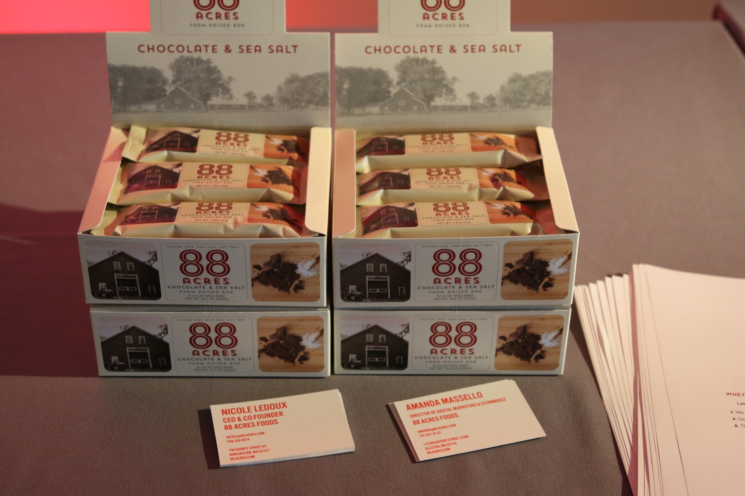 88 Acres Chocolate & Sea Salt bar display boxes with business cards on table.