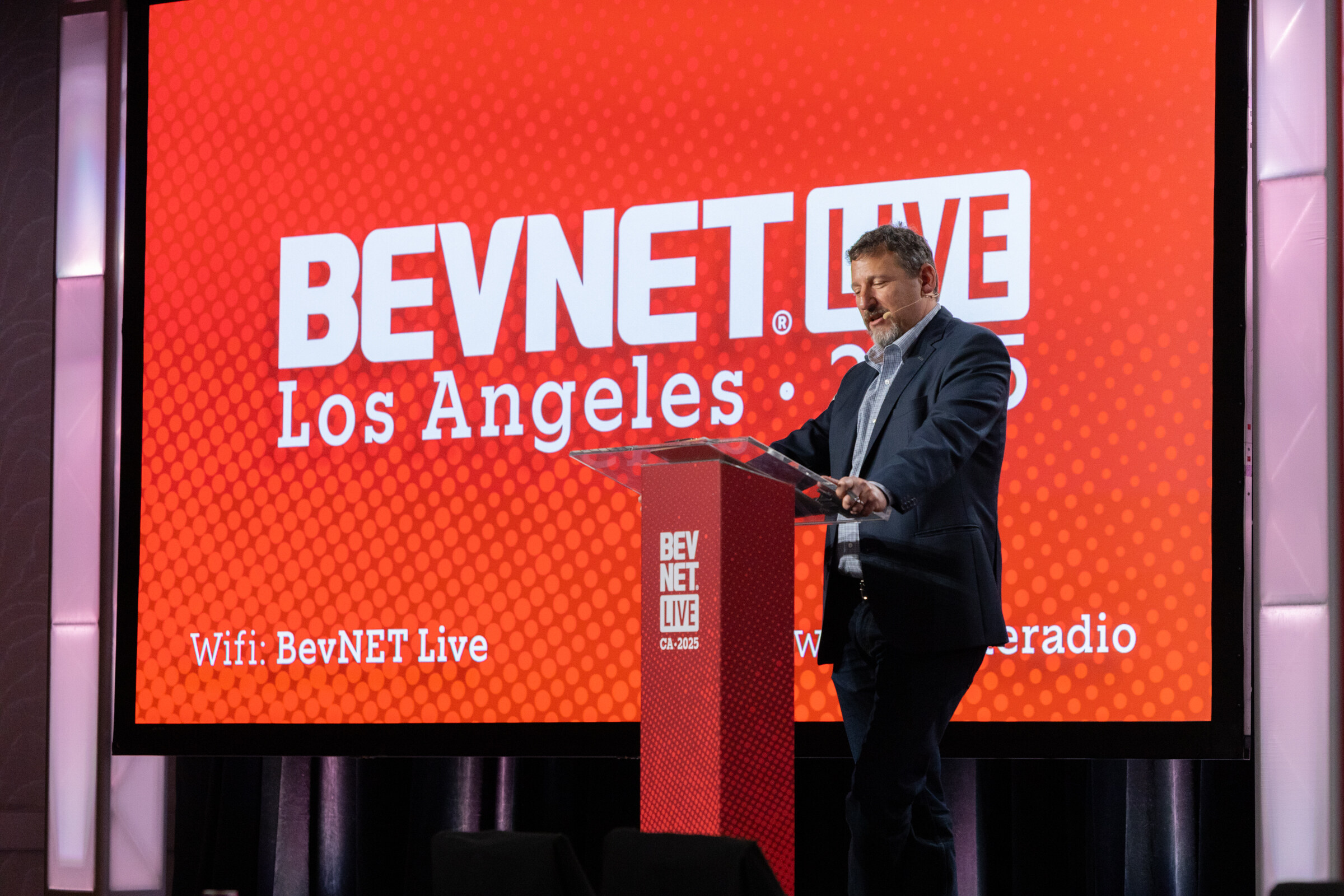 A man at the lectern beside a BevNET Live Los Angeles 2025 screen.