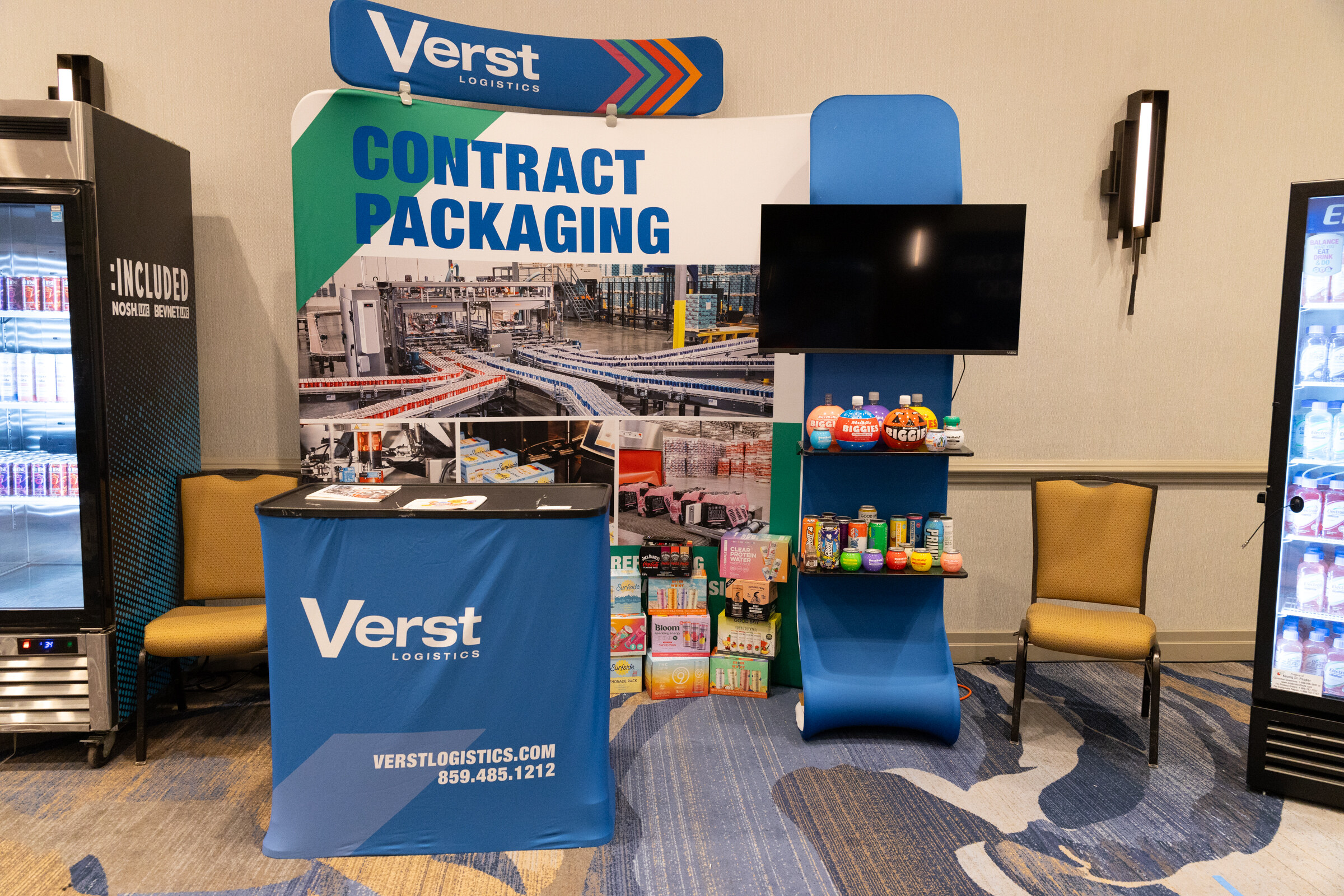 A Verst booth with a contract packaging backdrop and product display.