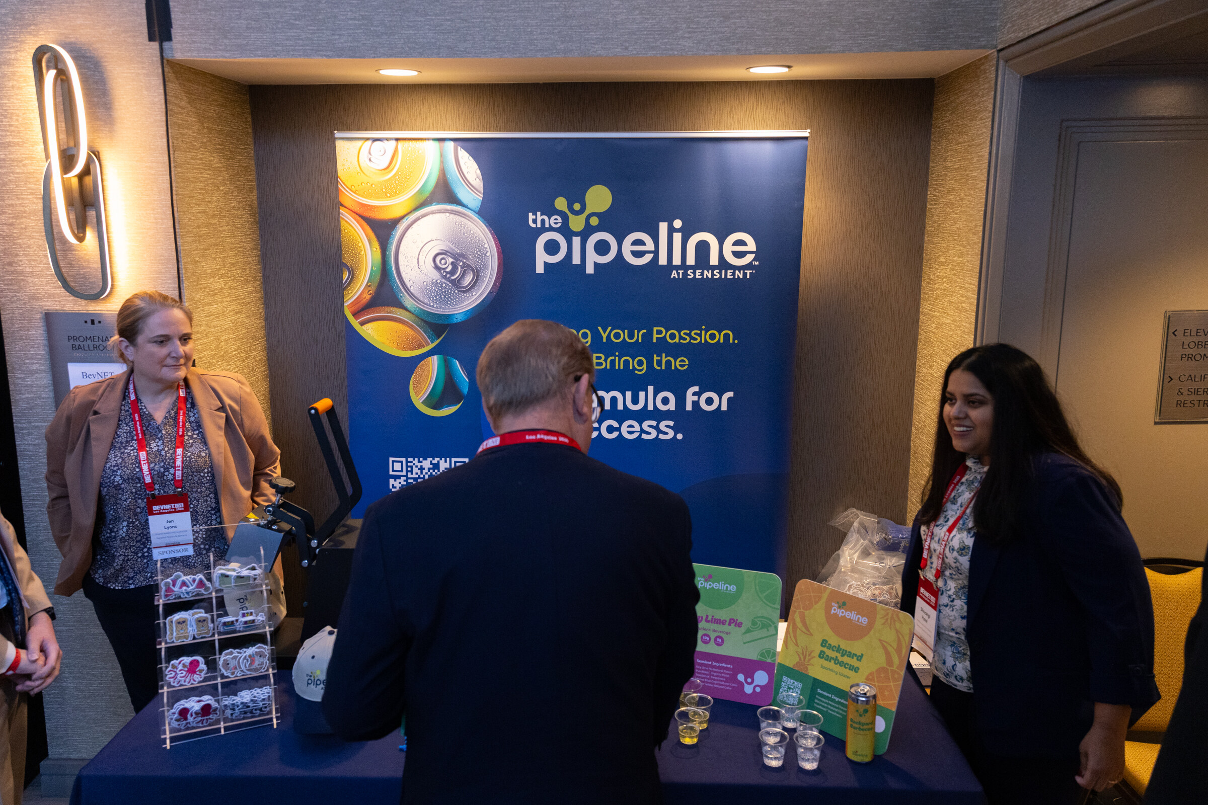Attendees look over a table of samples at a Pipeline booth.