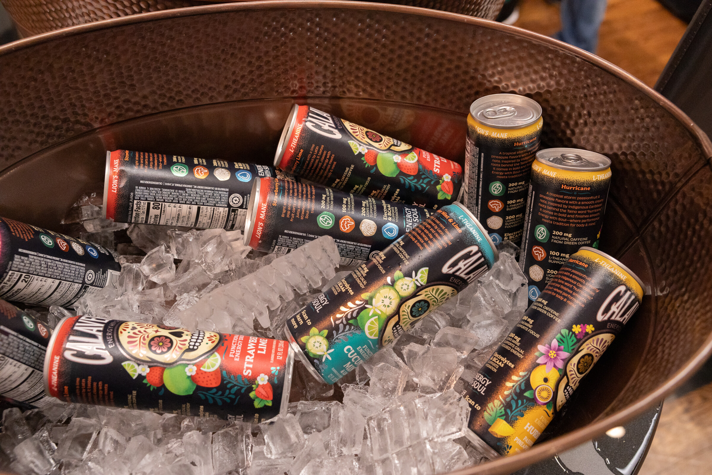 Copper tub of ice filled with colorful Calaveras Energy cans.