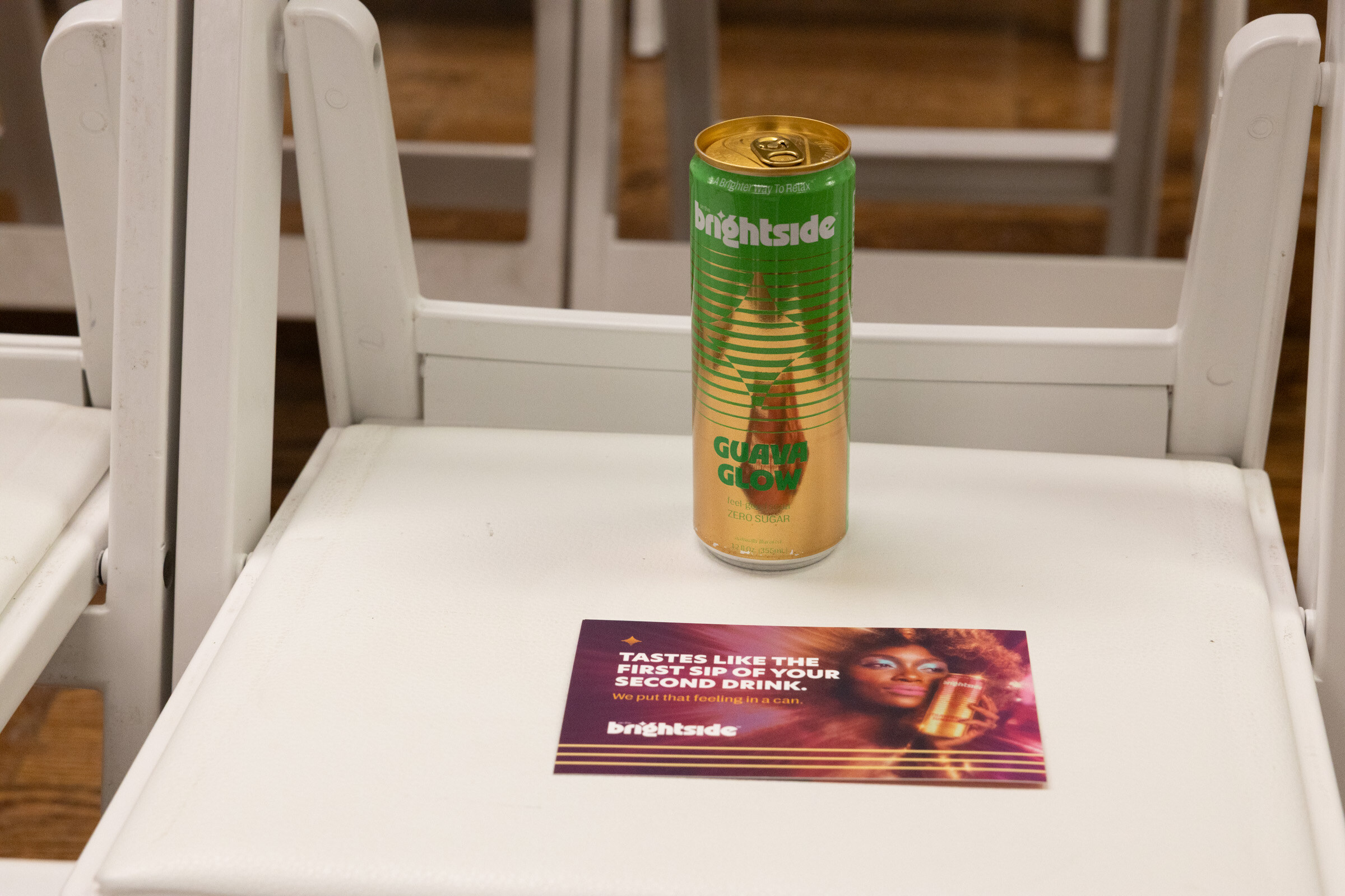 Close-up of a white chair holding a Brightside can and a printed Brightside card.