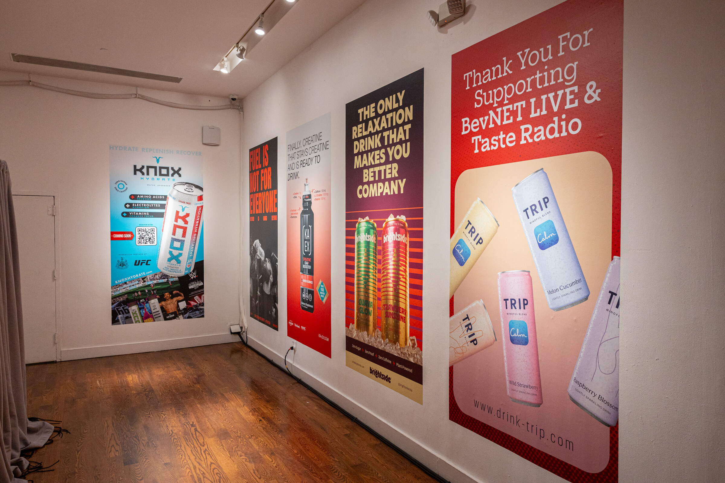 Hallway with sponsor posters including Knox, TRIP and a thank-you poster for supporting BevNET Live and Taste Radio.