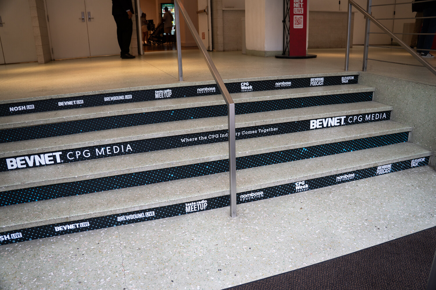Stone staircase with BevNET CPG Media branding printed on each step.