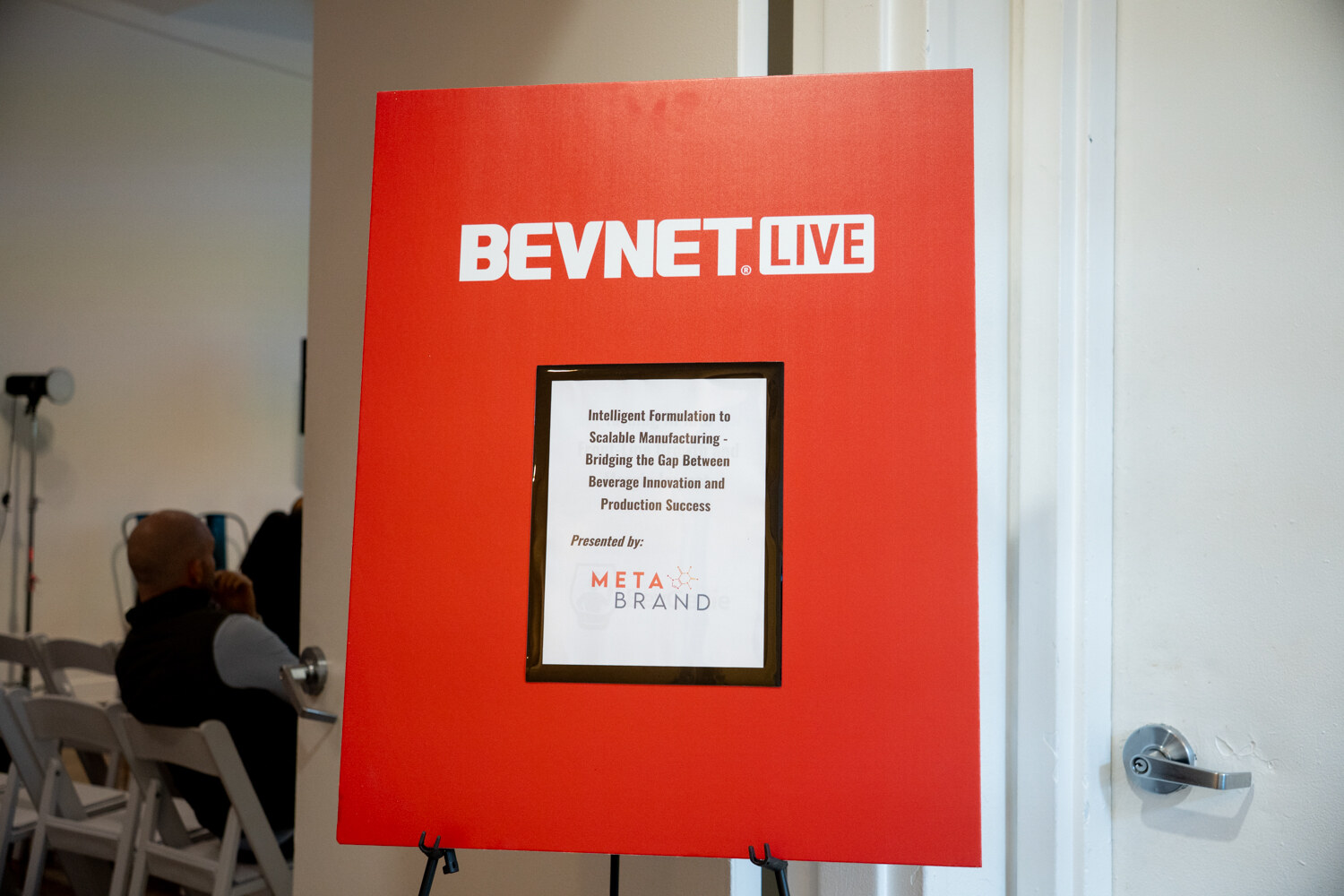Red BevNET Live easel sign with the Metabrand workshop title, outside the session room.